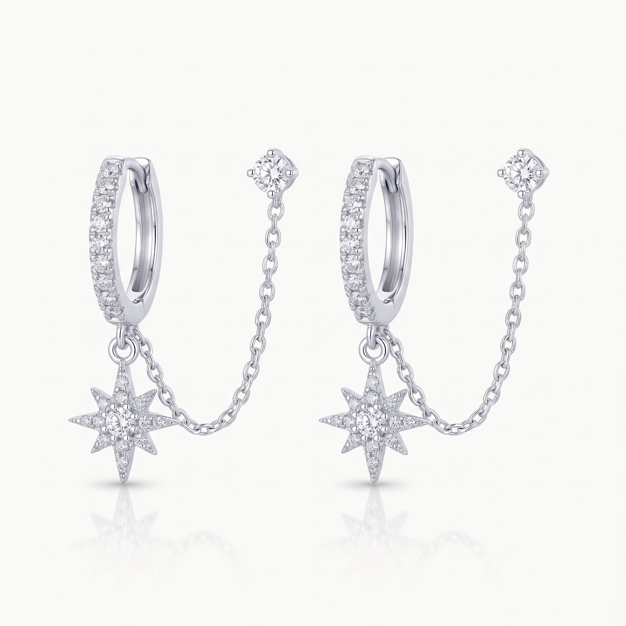 Silver-tone chained huggie earrings with star charm and crystal stud