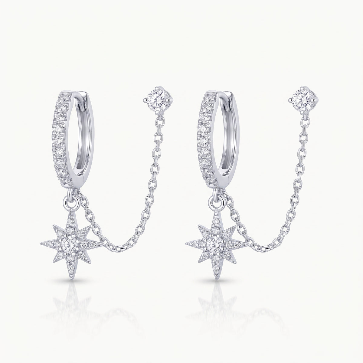 Silver-tone chained huggie earrings with star charm and crystal stud