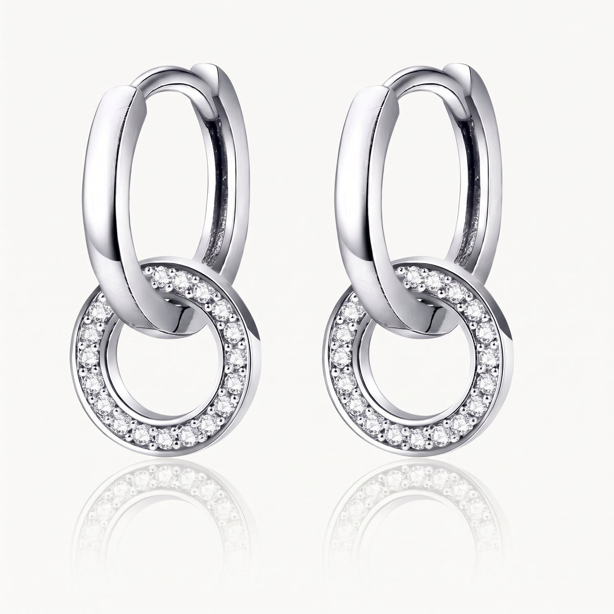Silver-tone interlocking hoop earrings with a crystal-set ring