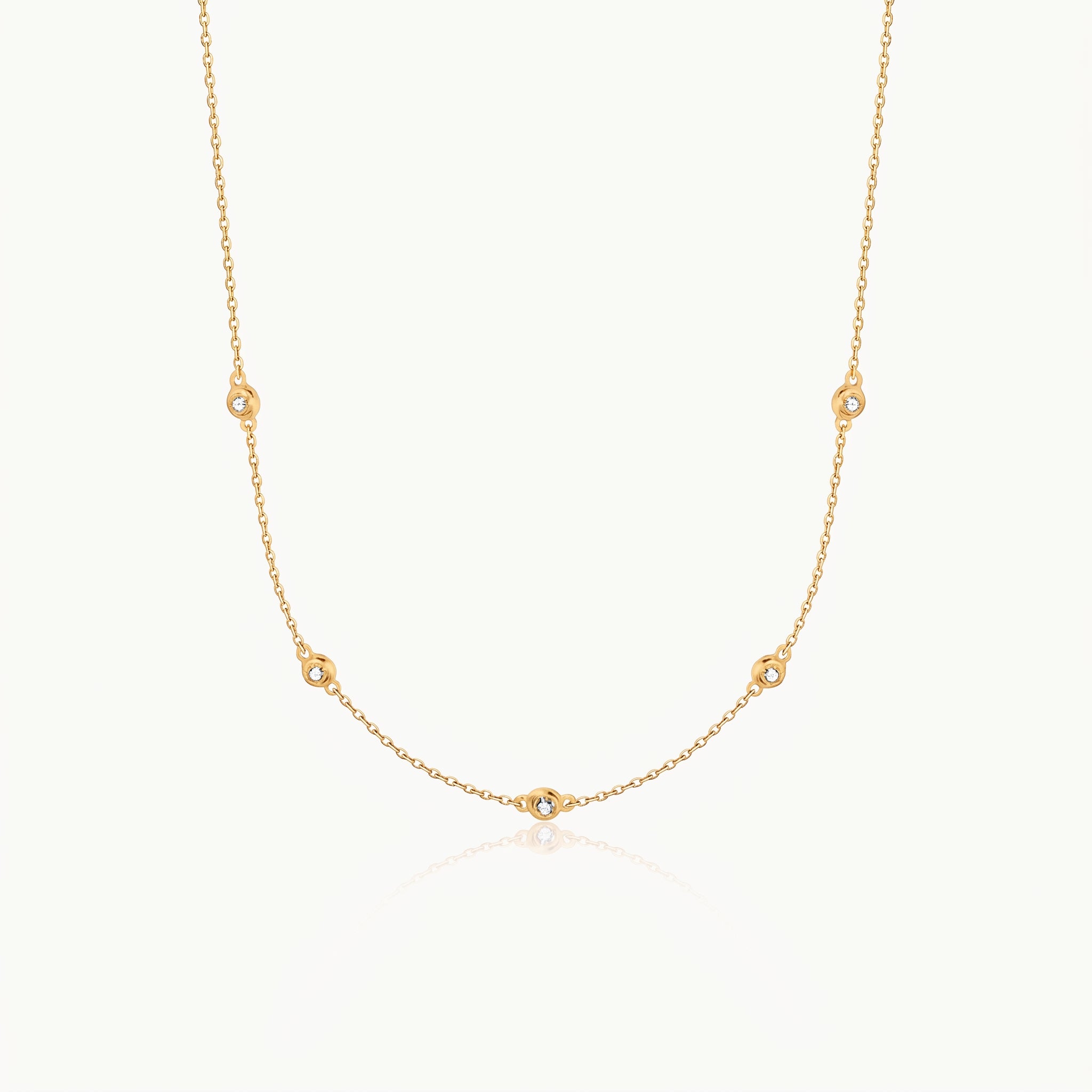 Gold-tone crystal necklace with five stones on a fine chain