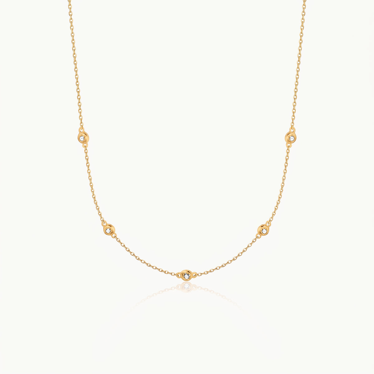 Gold-tone crystal necklace with five stones on a fine chain