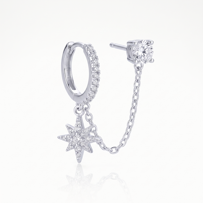 Silver-tone chained huggie earring showing the chain between hoop and stud