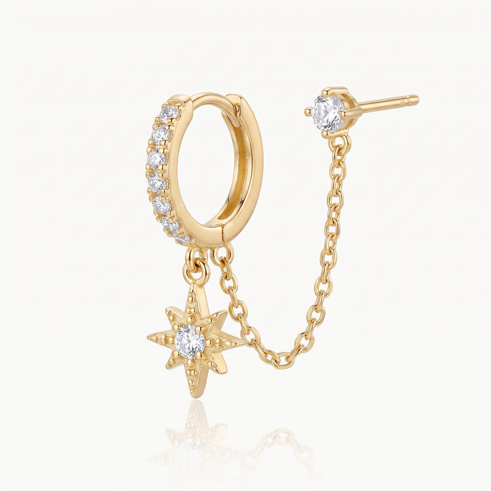 Close-up of the chain linking the gold-tone huggie and stud