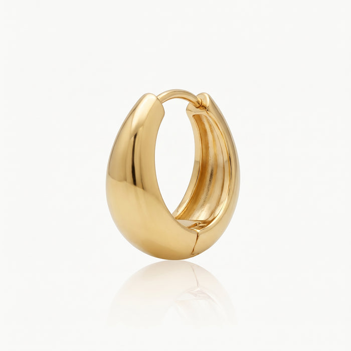 Close-up of a gold-tone chunky hoop earring