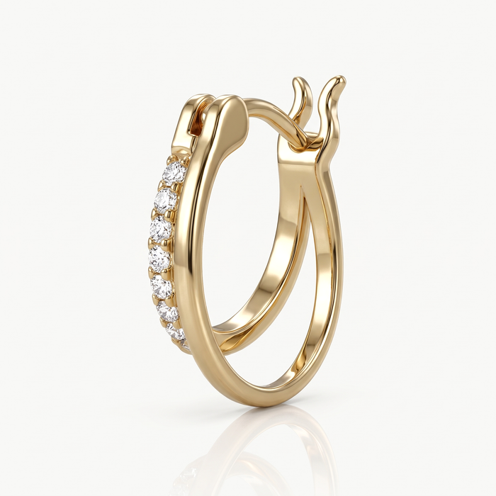 Close-up of a gold-tone double hoop earring with a crystal band