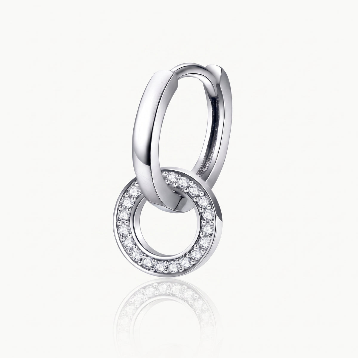 Close-up of a silver-tone interlocking hoop earring