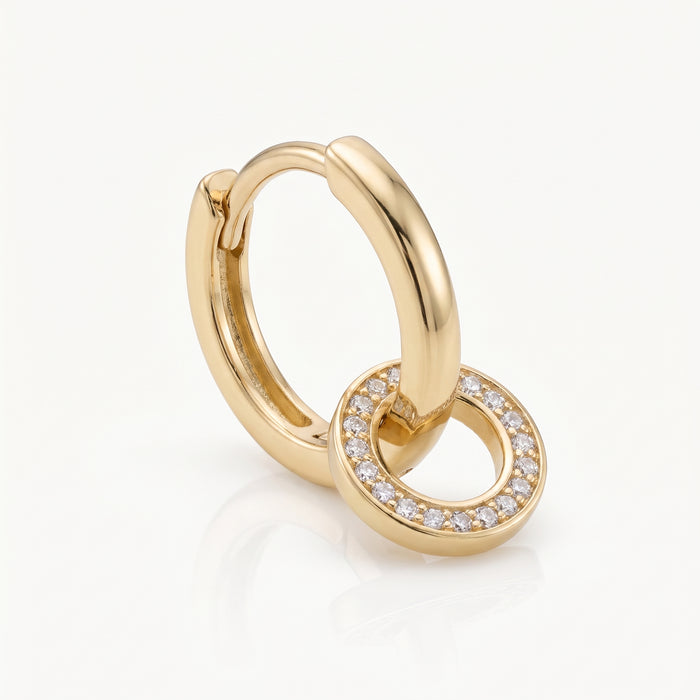 Close-up of a gold-tone interlocking hoop earring