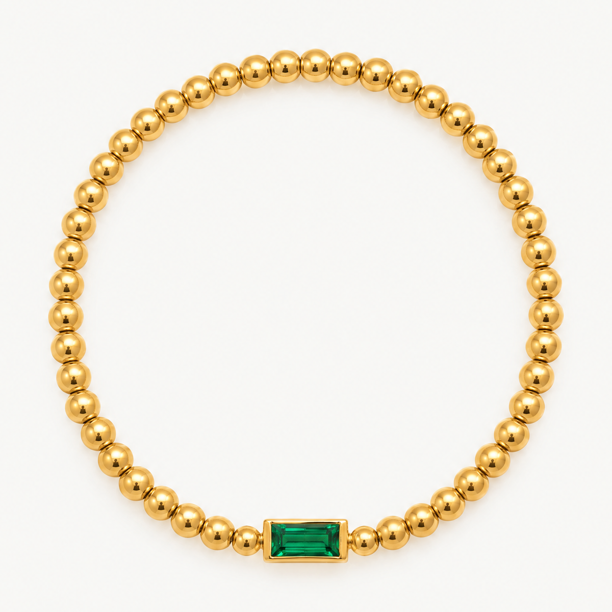 Gold-tone beaded birthstone bracelet with a green baguette stone
