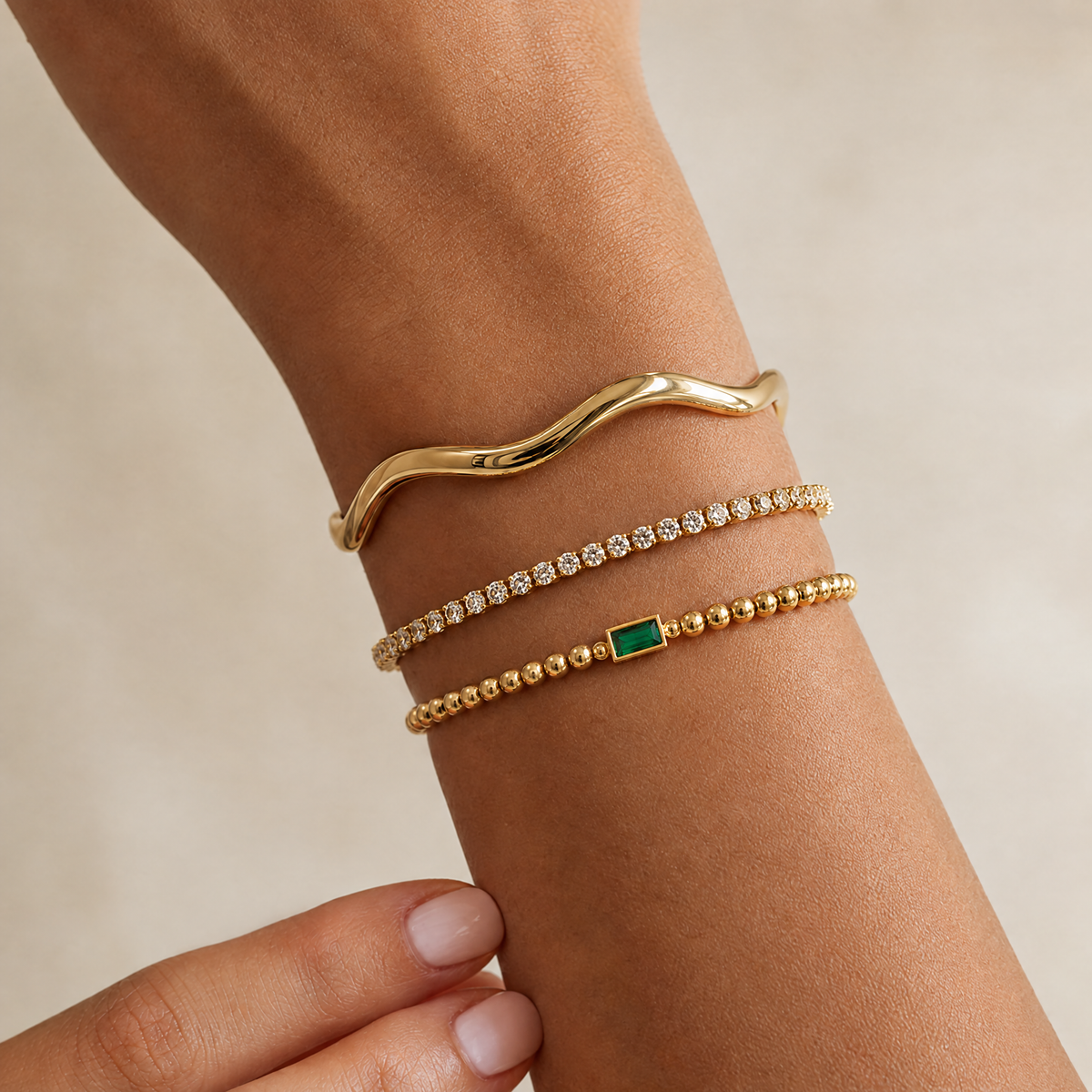 Beaded birthstone bracelet on the wrist, stacked with other bracelets