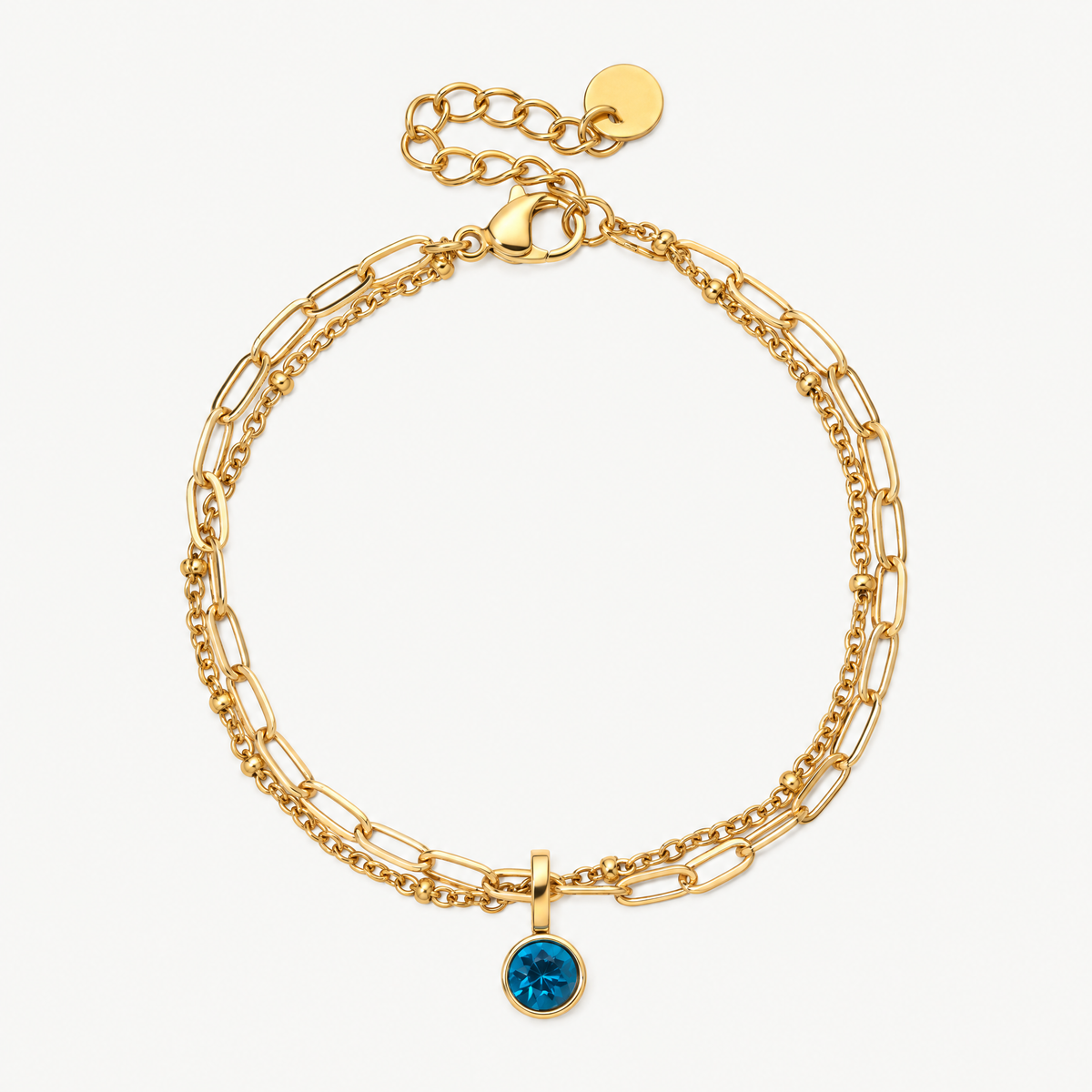 Gold-tone layered paperclip chain birthstone bracelet with a round blue charm