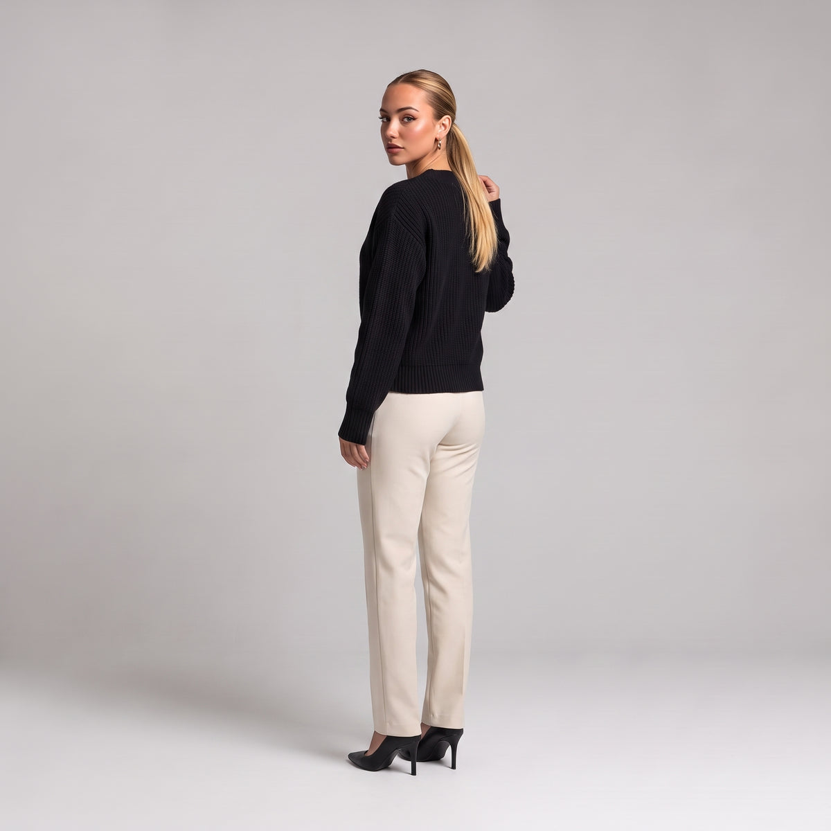 Black chunky knit cardigan, back three quarter view on model