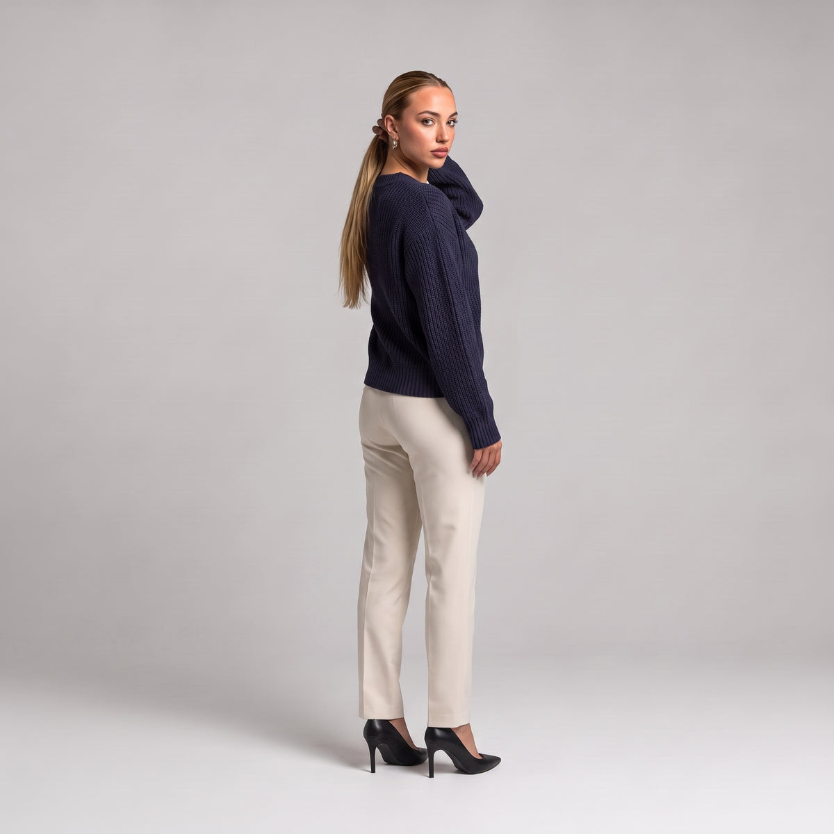 Navy chunky knit cardigan, back three quarter view on model