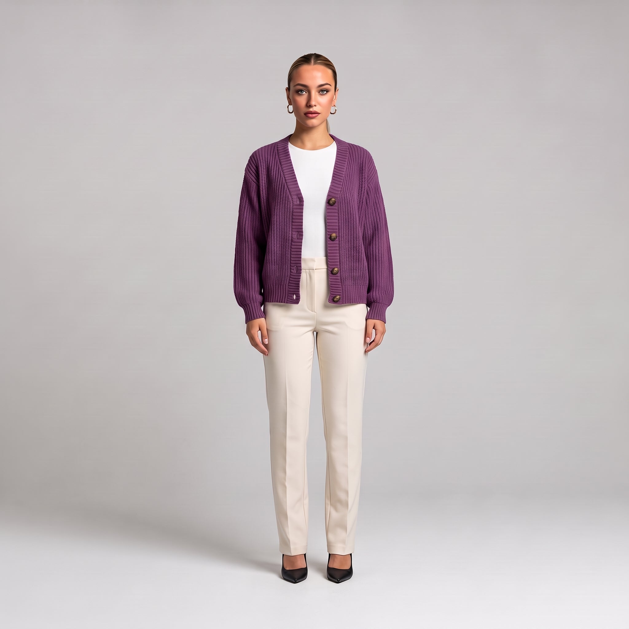 Purple chunky knit cardigan worn open over a white top, full length front view
