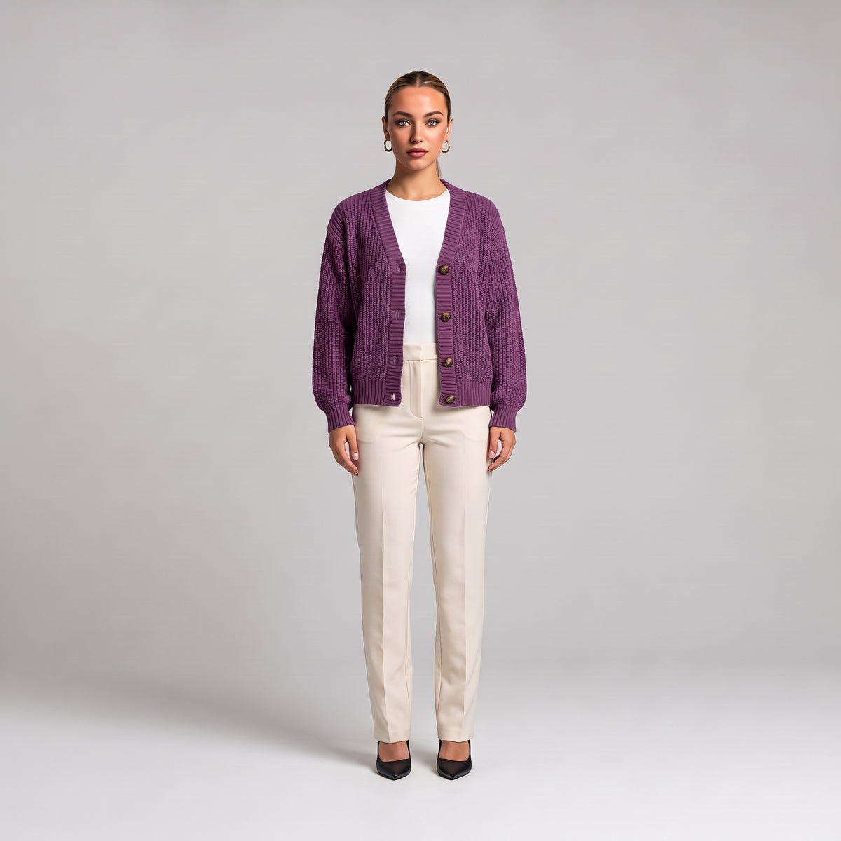 Purple chunky knit cardigan worn open over a white top, full length front view