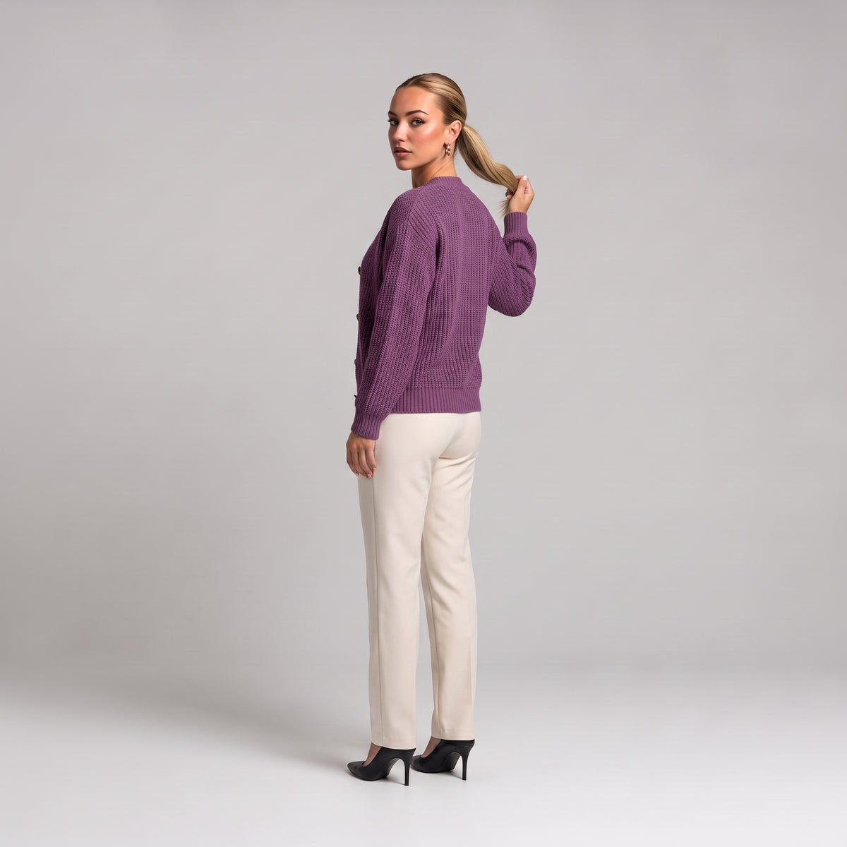 Purple chunky knit cardigan, back three quarter view on model