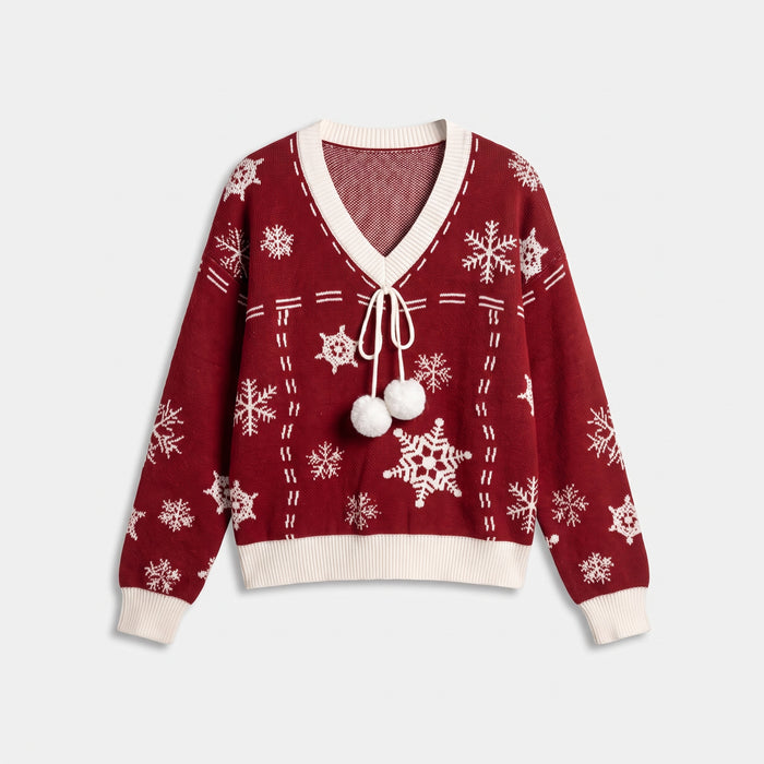 Red Christmas jumper laid flat, snowflake pattern and scalloped hem