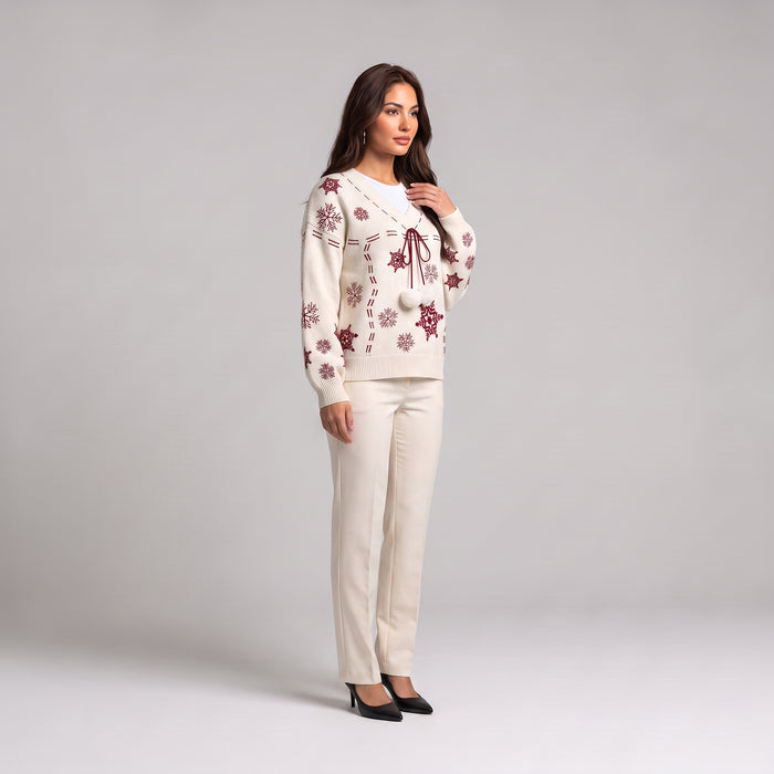 White Christmas jumper side view, worn with cream trousers