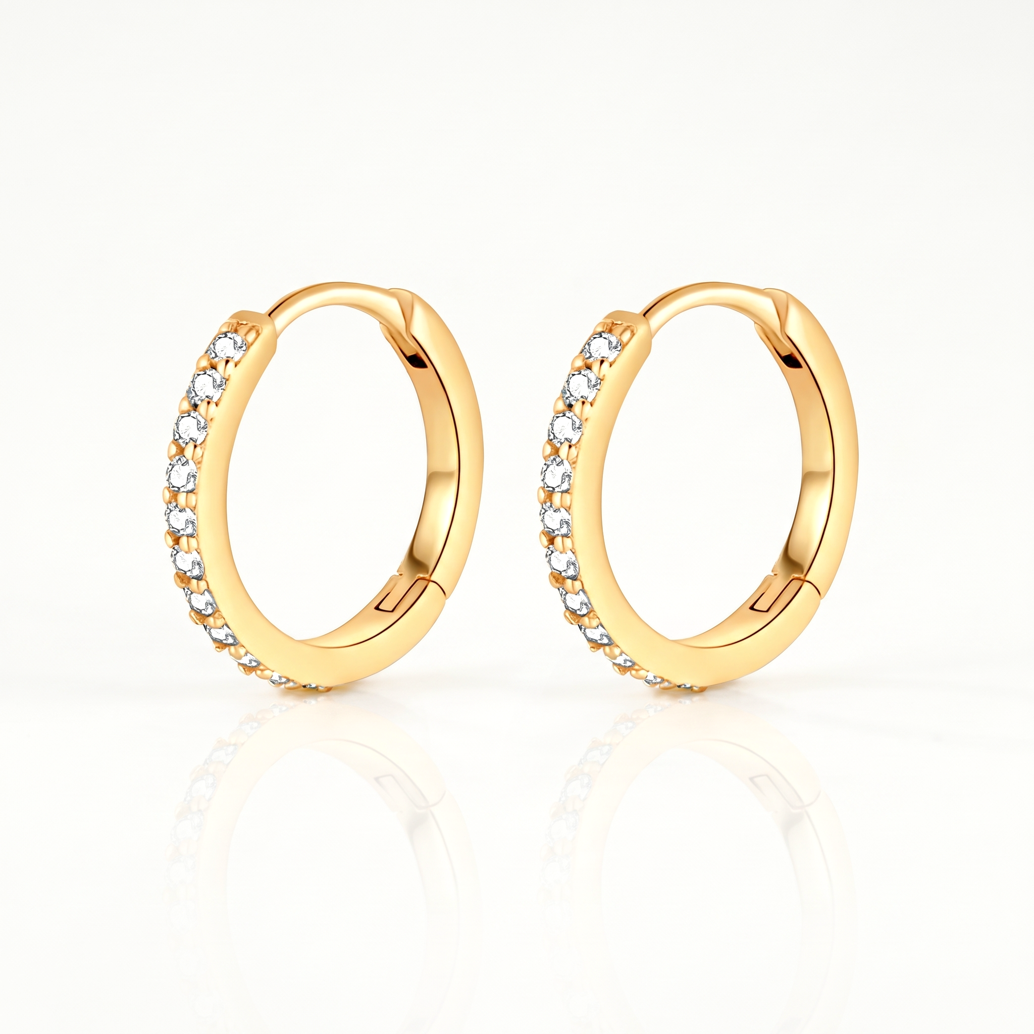 Gold-tone crystal huggie hoop earrings, pair shown from the front
