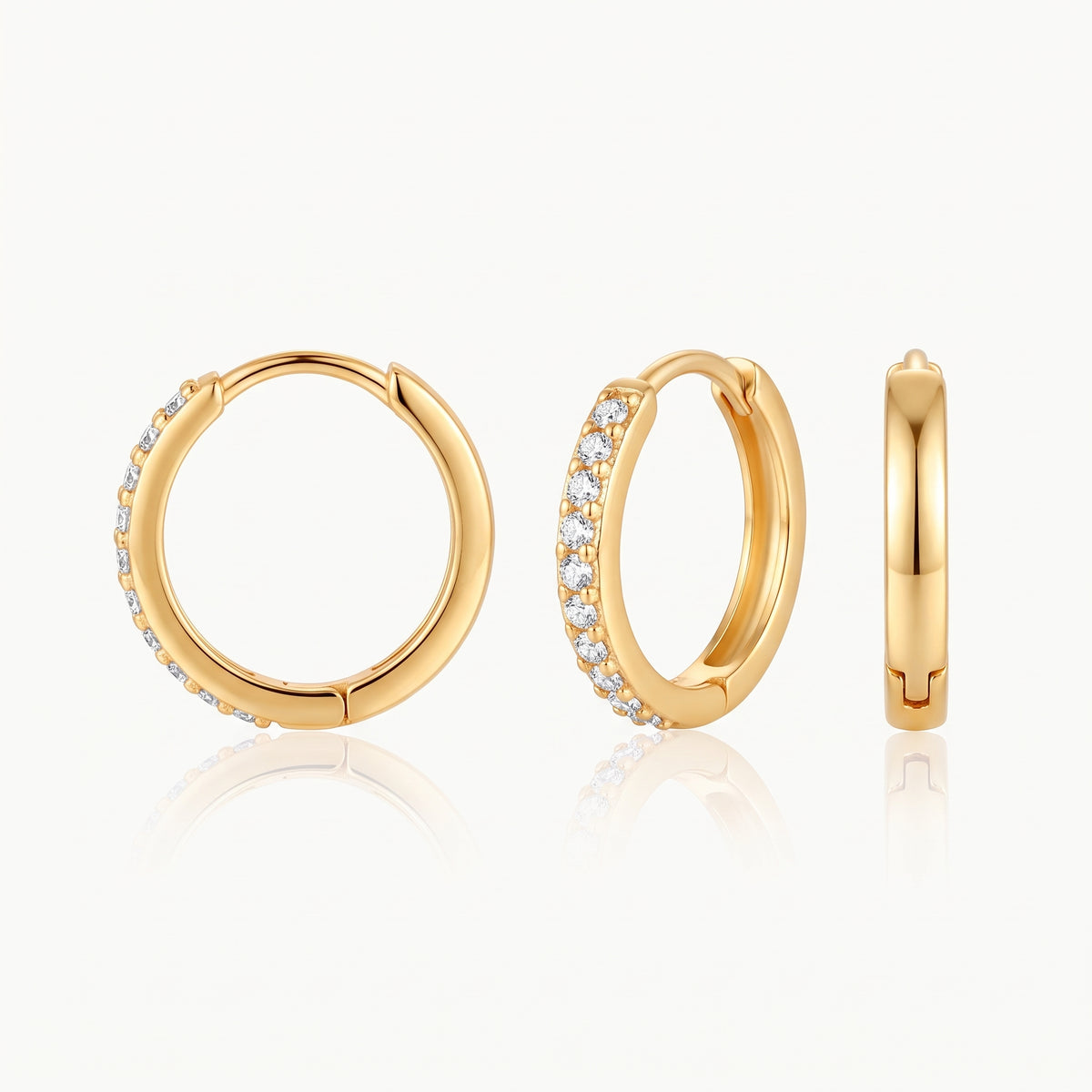 Gold-tone crystal huggie hoop earring shown from the front, at an angle and from the side