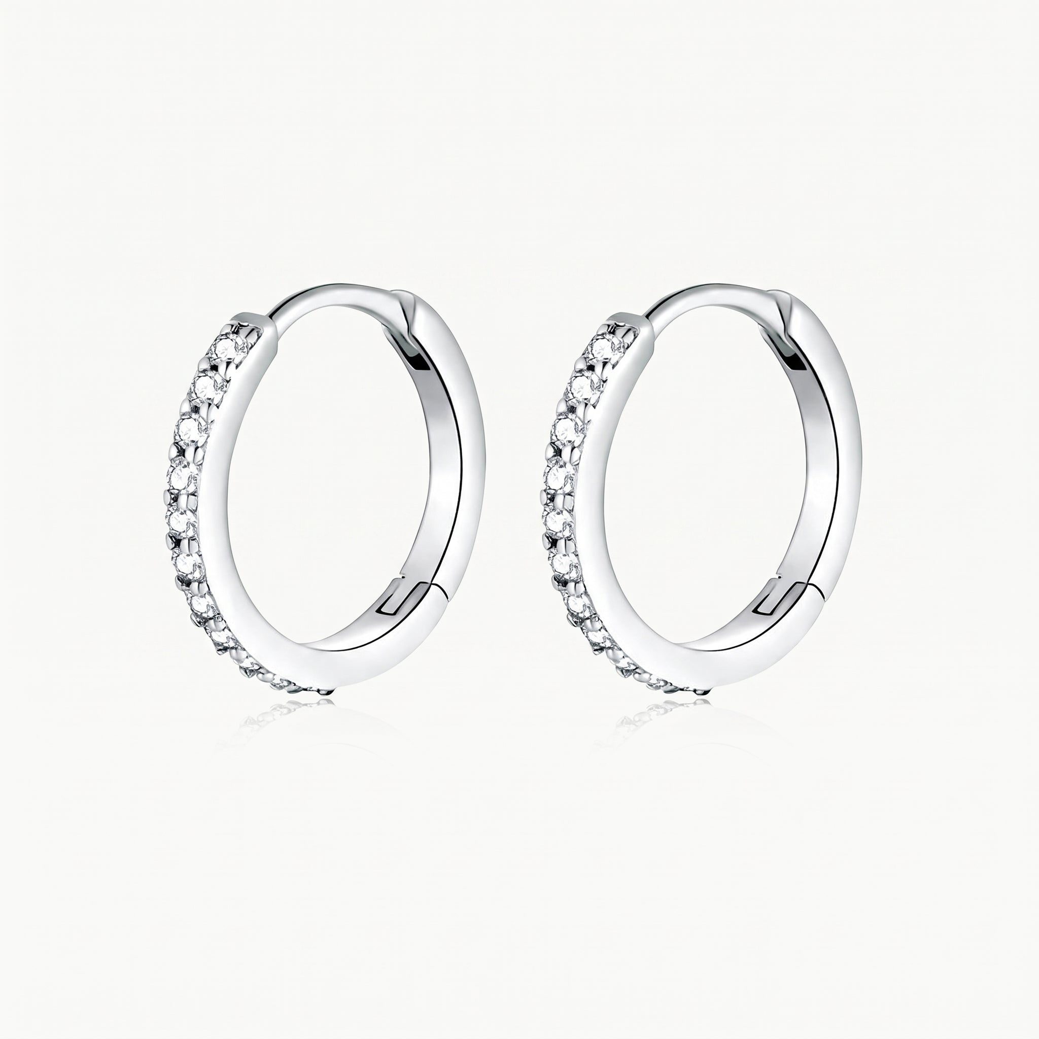 Silver-tone crystal huggie hoop earrings, pair shown from the front