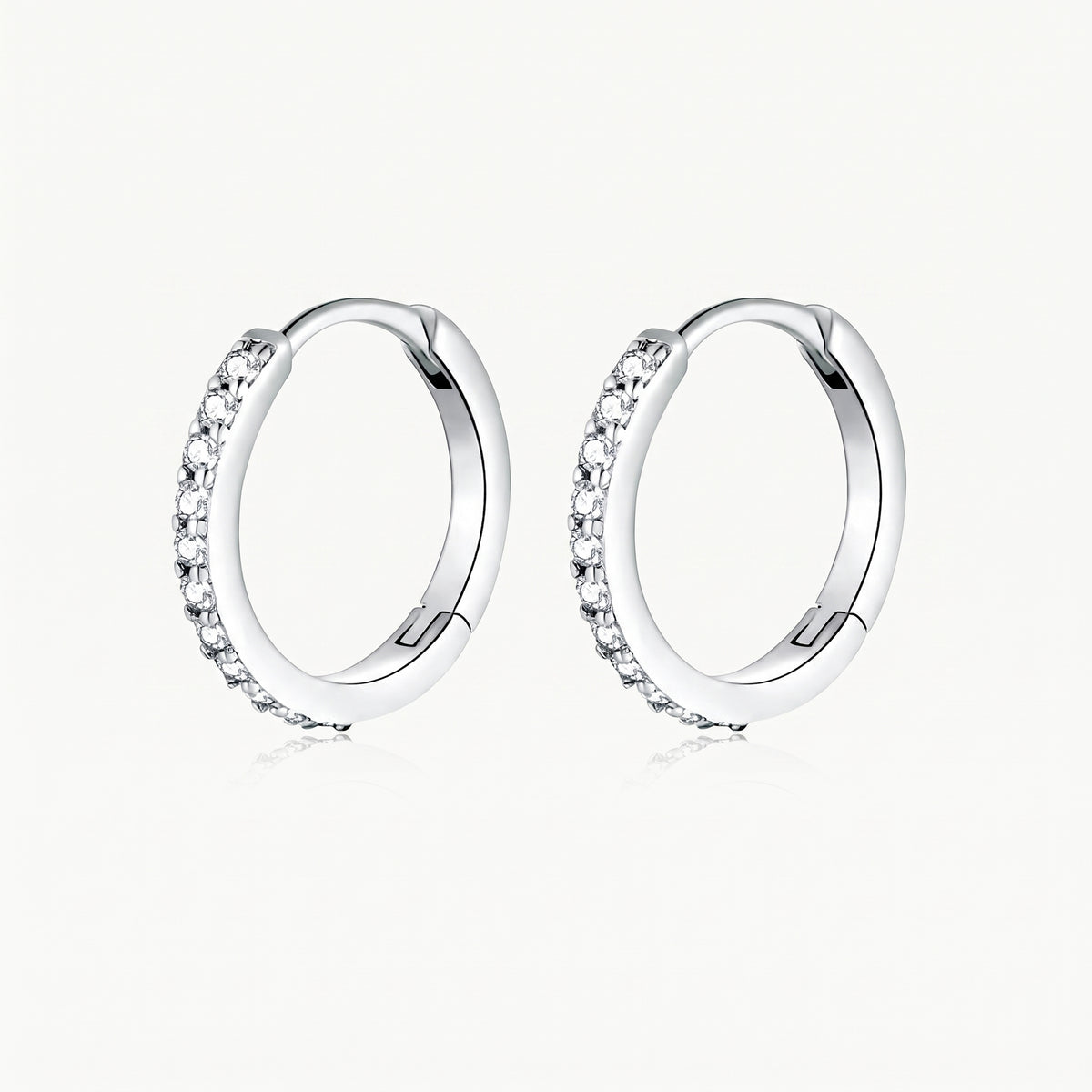 Silver-tone crystal huggie hoop earrings, pair shown from the front