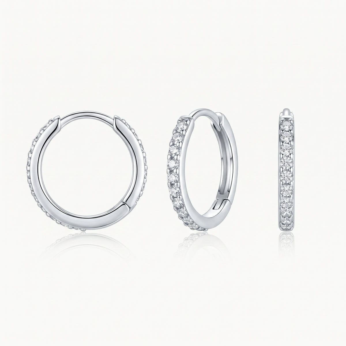 Silver-tone crystal huggie hoop earring shown from the front, at an angle and from the side