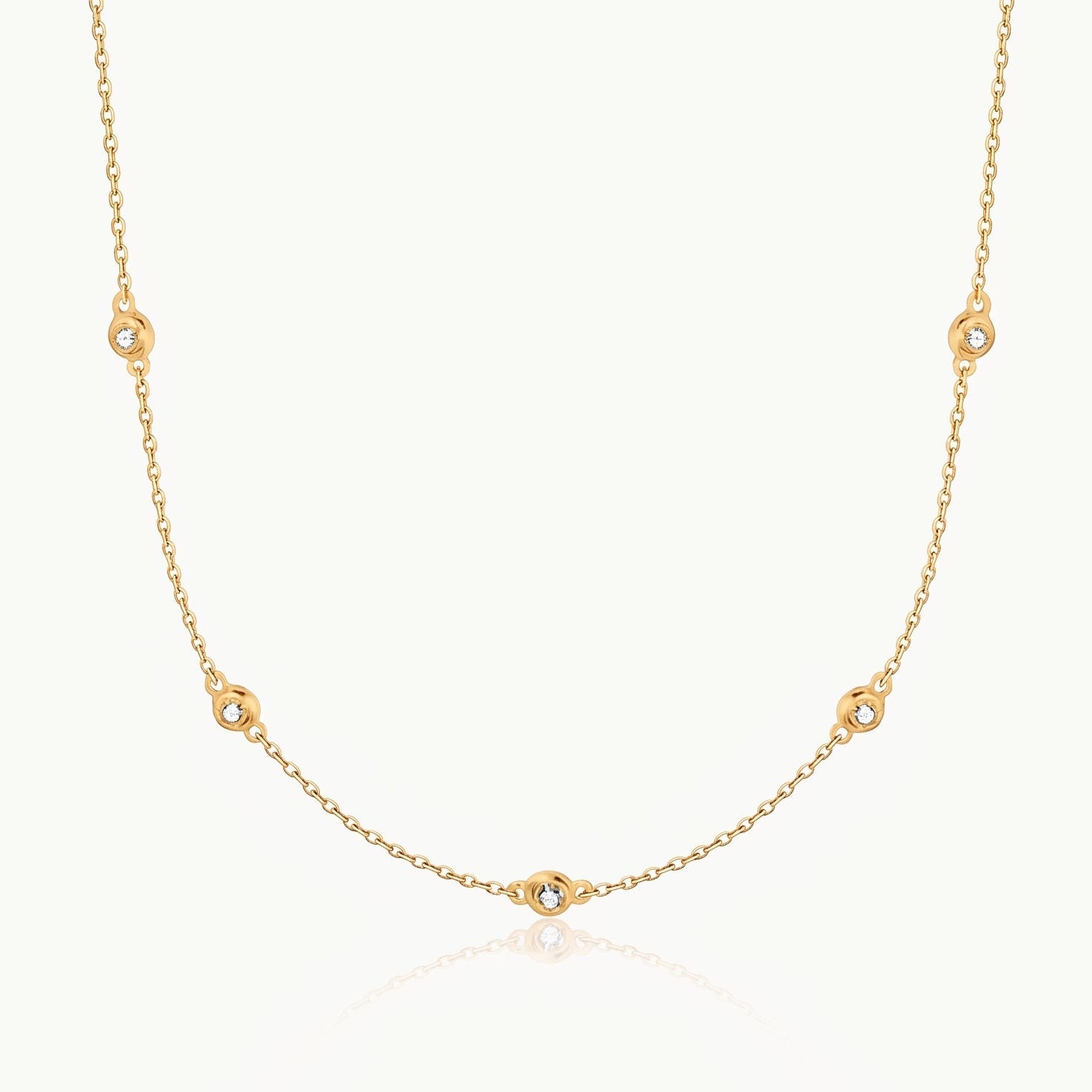 Gold-tone crystal necklace with five stones on a fine chain