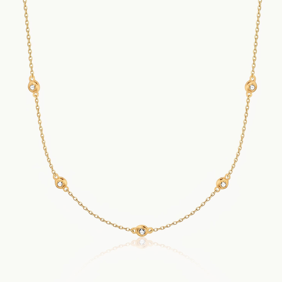 Gold-tone crystal necklace with five stones on a fine chain