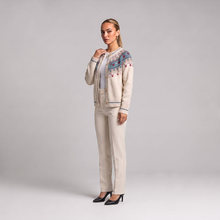 White Fair Isle Christmas cardigan, side view worn with cream trousers