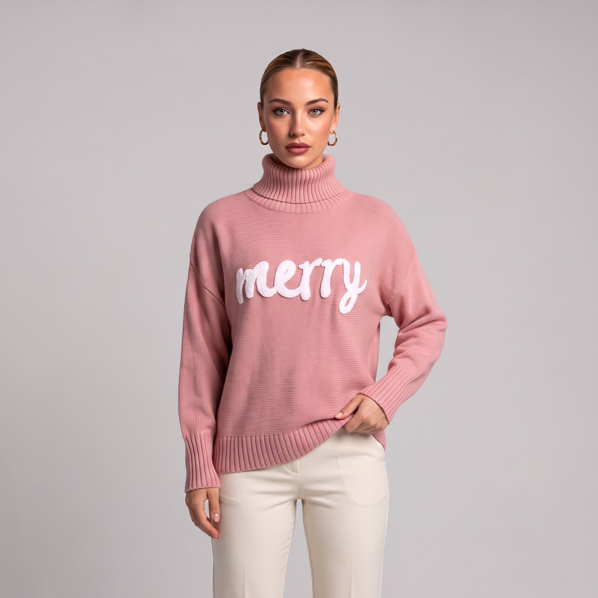 Close-up of pink merry roll neck Christmas jumper on model