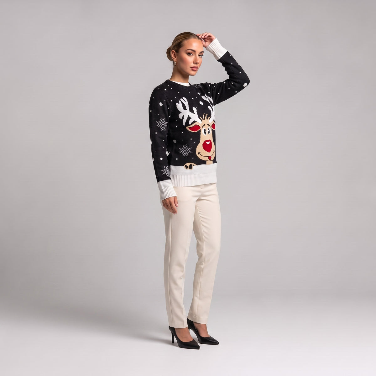 Black reindeer face Christmas jumper, three quarter view on model