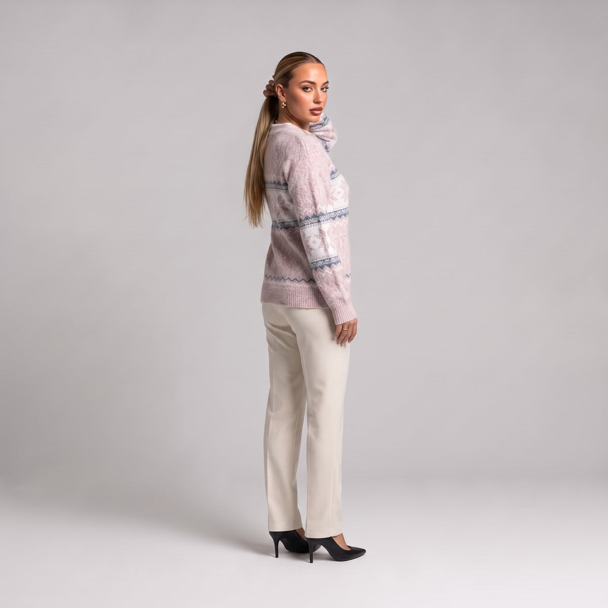 Baby pink snowflake chenille Christmas jumper, three quarter view on model