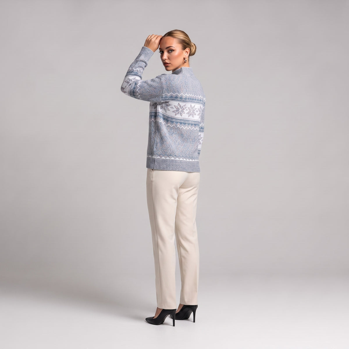 Grey snowflake chenille Christmas jumper, three quarter view on model