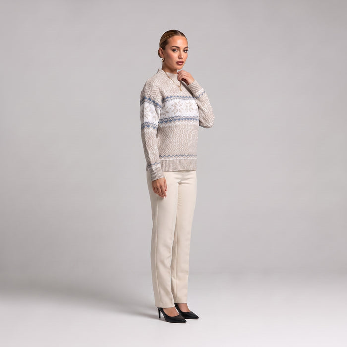 Beige snowflake chenille Christmas jumper, side view worn with cream trousers