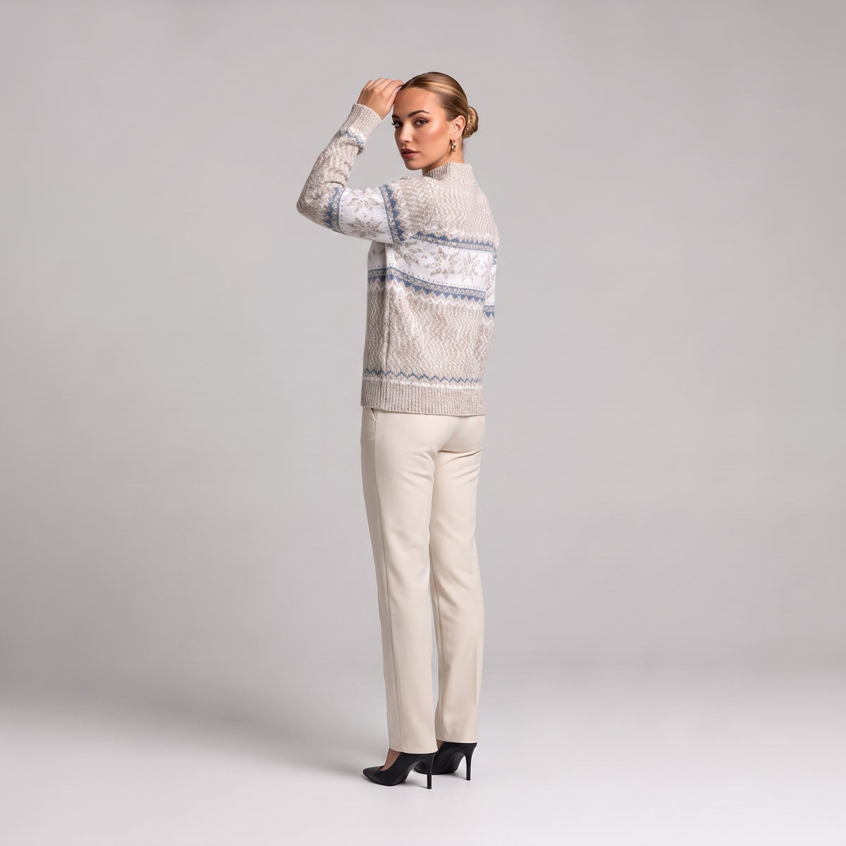 Beige snowflake chenille Christmas jumper, three quarter view on model