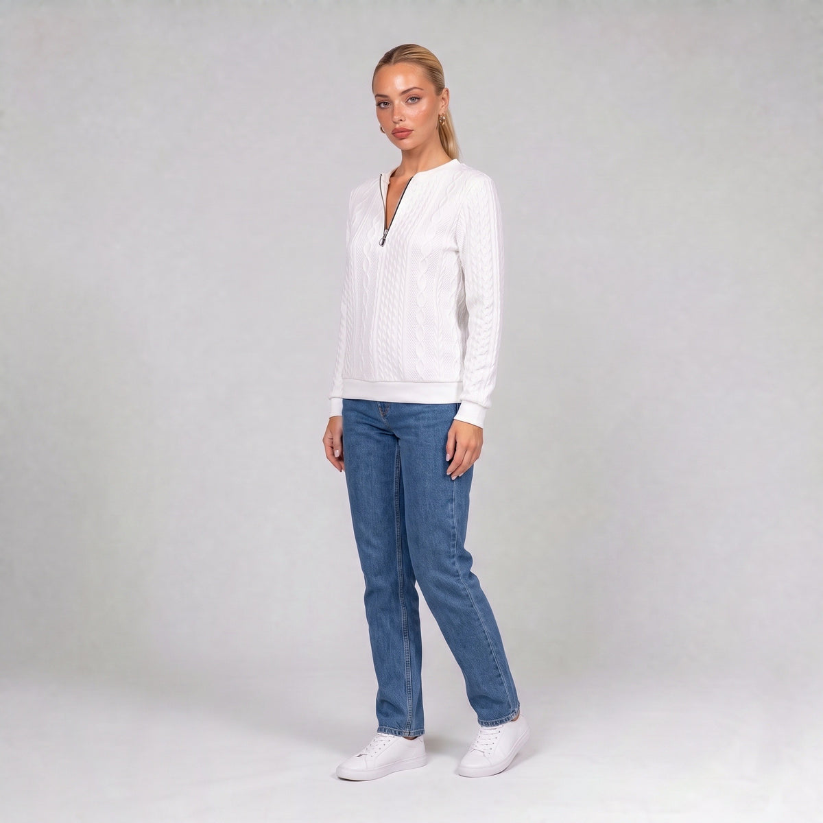 White quarter zip cable knit jumper, three quarter view on model