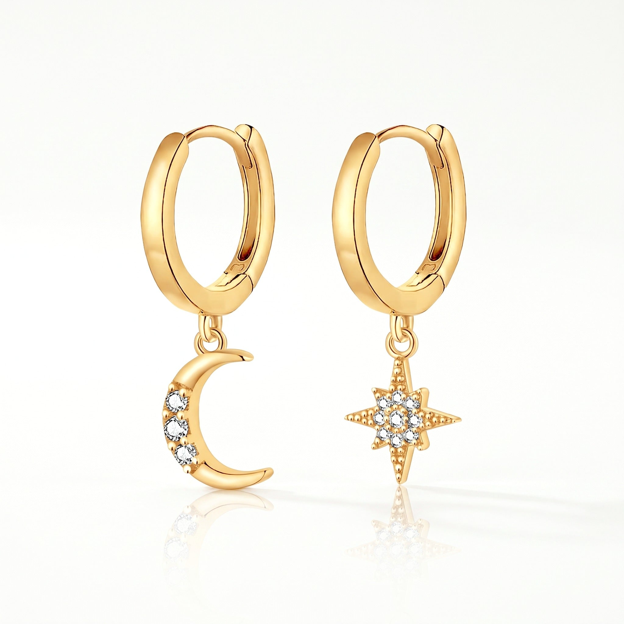 Gold-tone moon and star huggie earrings, pair shown from the front