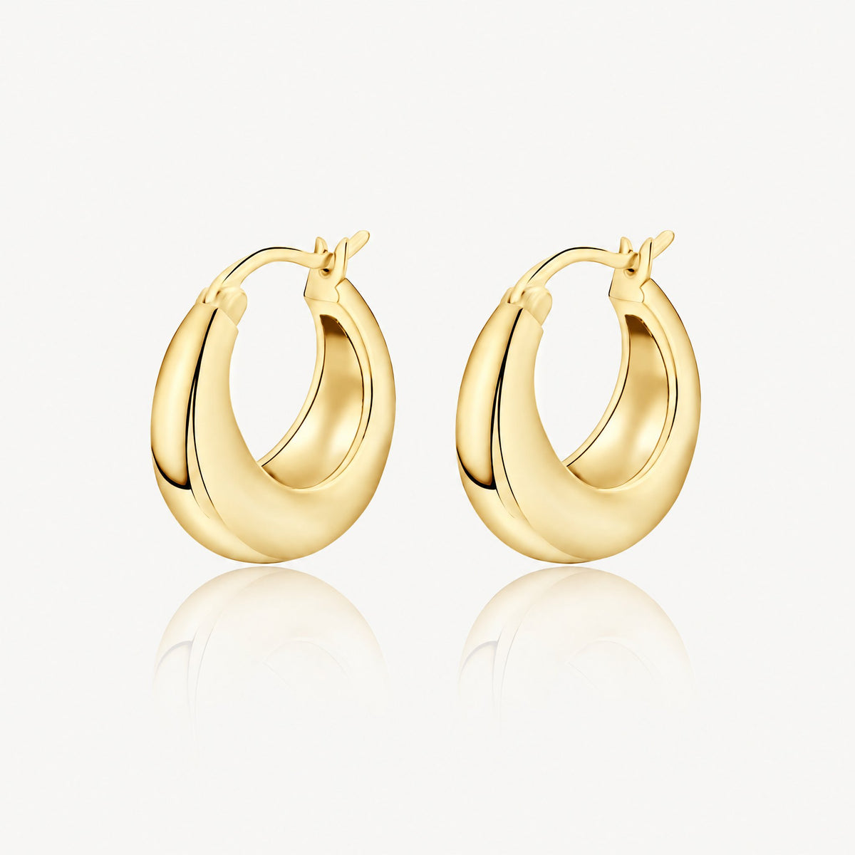 Gold-tone chunky tapered hoop earrings, pair shown from the front