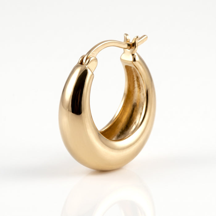 Close-up of the gold-tone chunky hoop and hinged closure