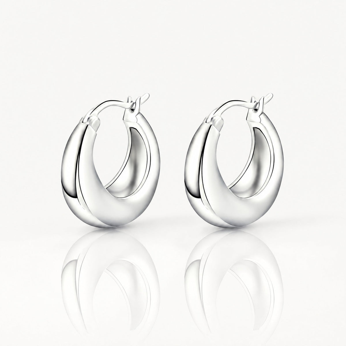 Silver-tone chunky tapered hoop earrings, pair shown from the front