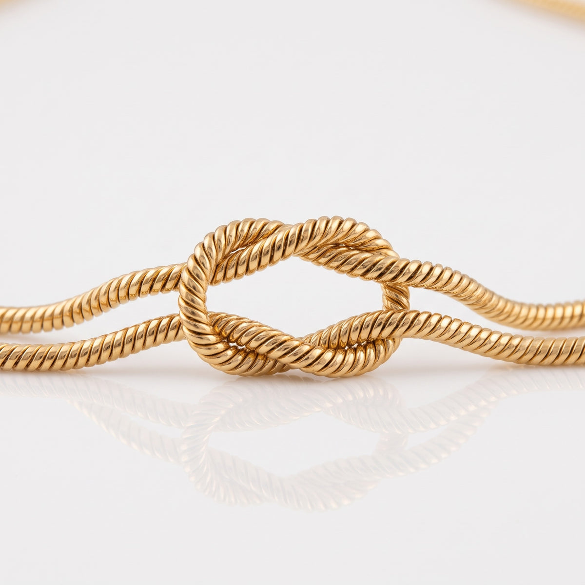 Close-up of the knot in the gold-tone snake chain