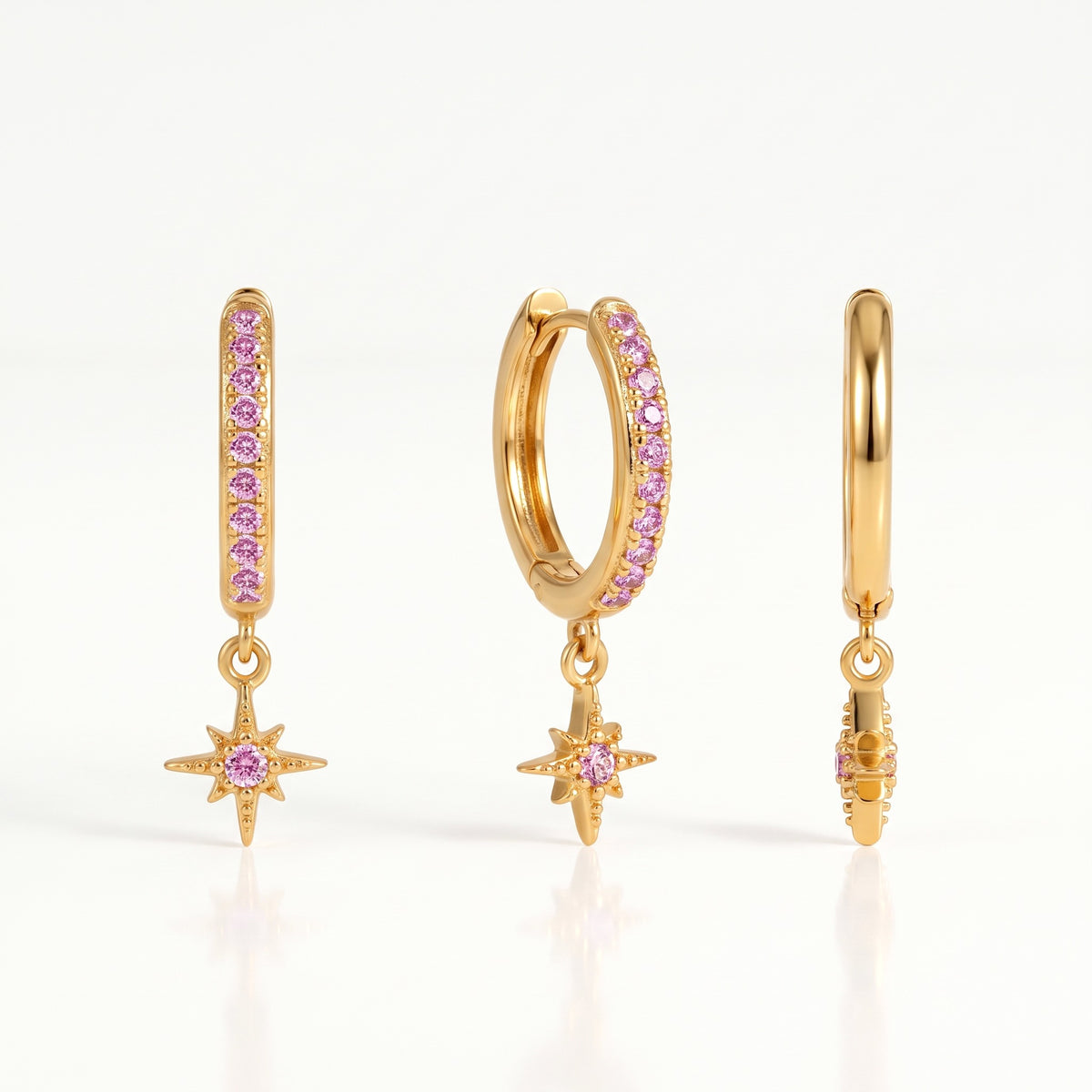 Gold-tone star charm huggie hoop earrings with pink crystals, front and side view