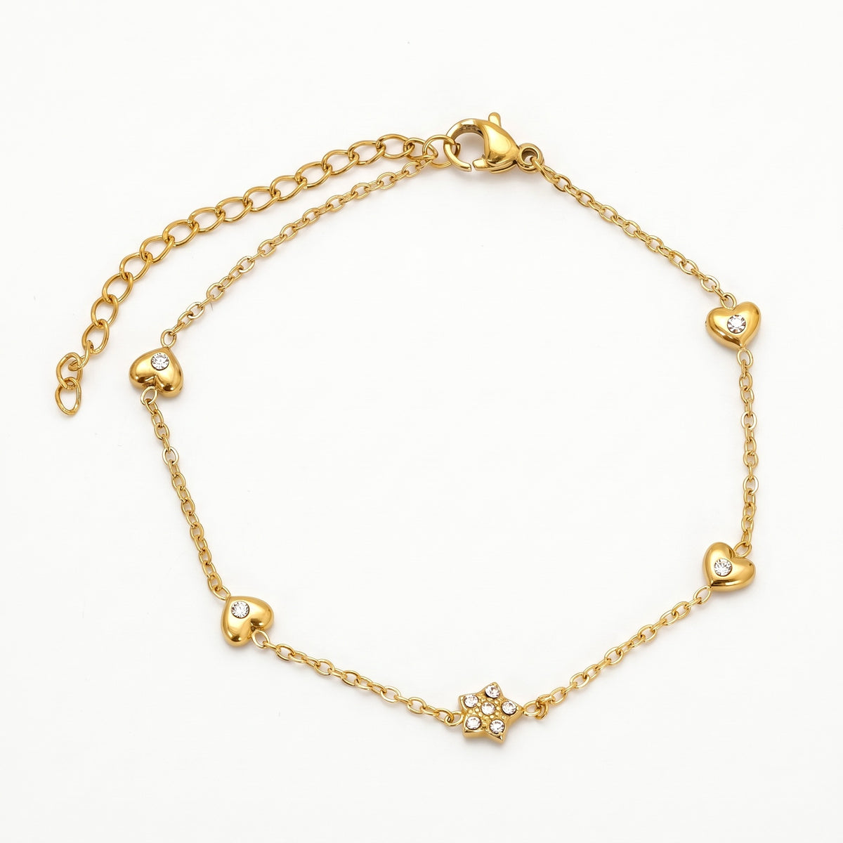 Gold-tone heart charm bracelet with a crystal star