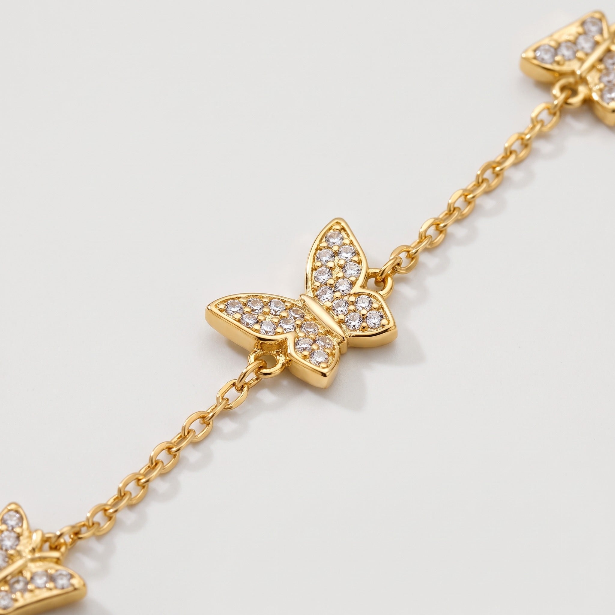Close-up of the crystal butterflies on the gold-tone chain