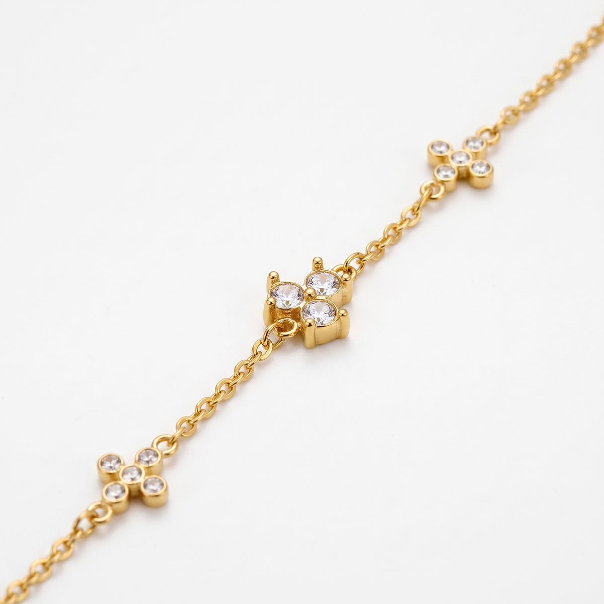 Close-up of the crystal clovers on the gold-tone chain