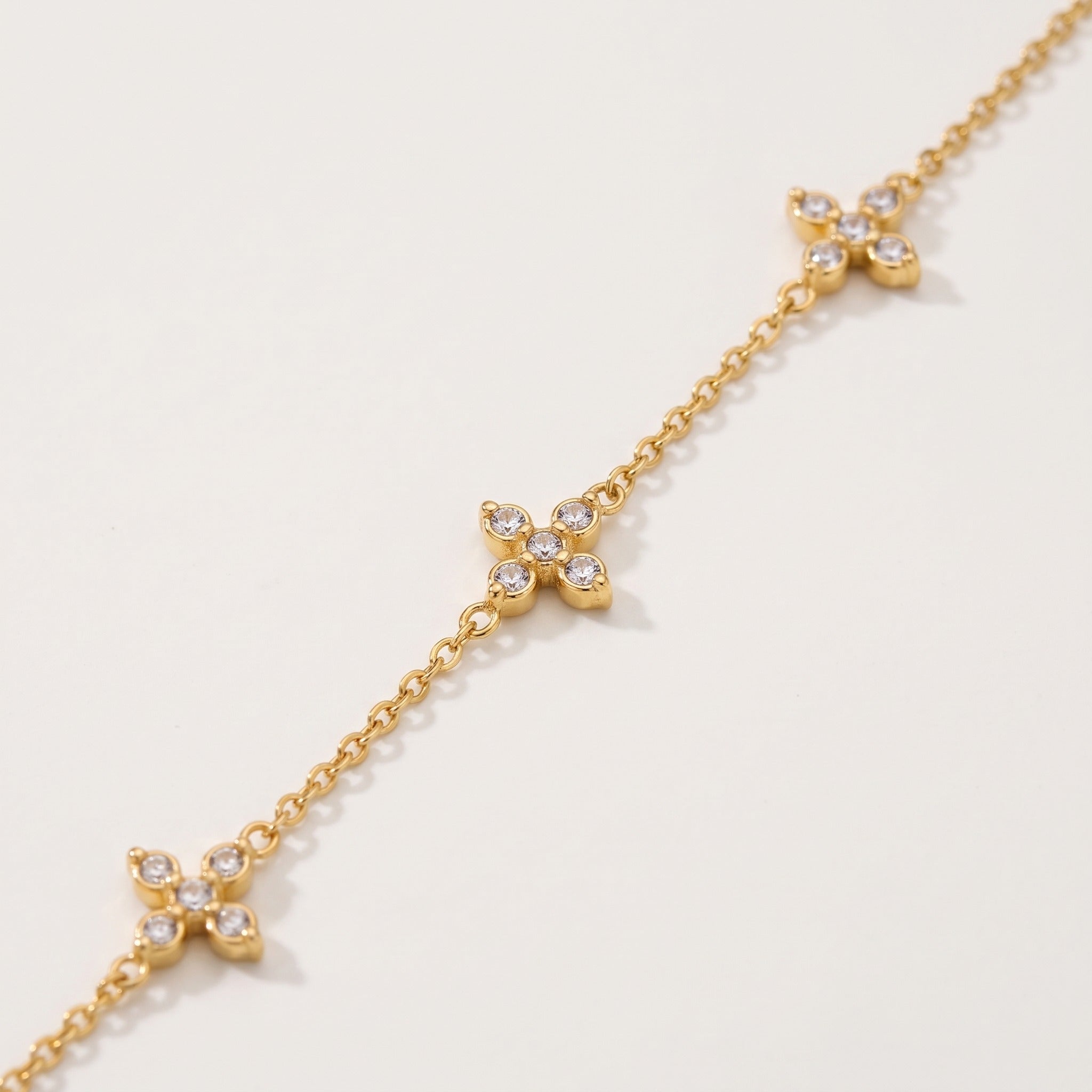 Close-up of the crystal crosses on the gold-tone chain