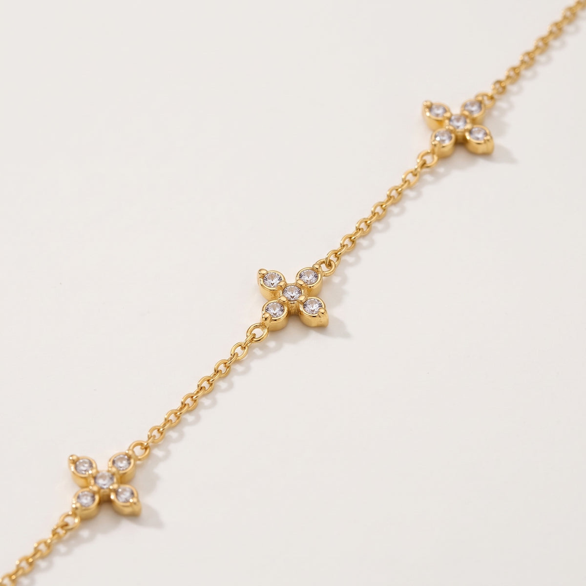 Close-up of the crystal crosses on the gold-tone chain