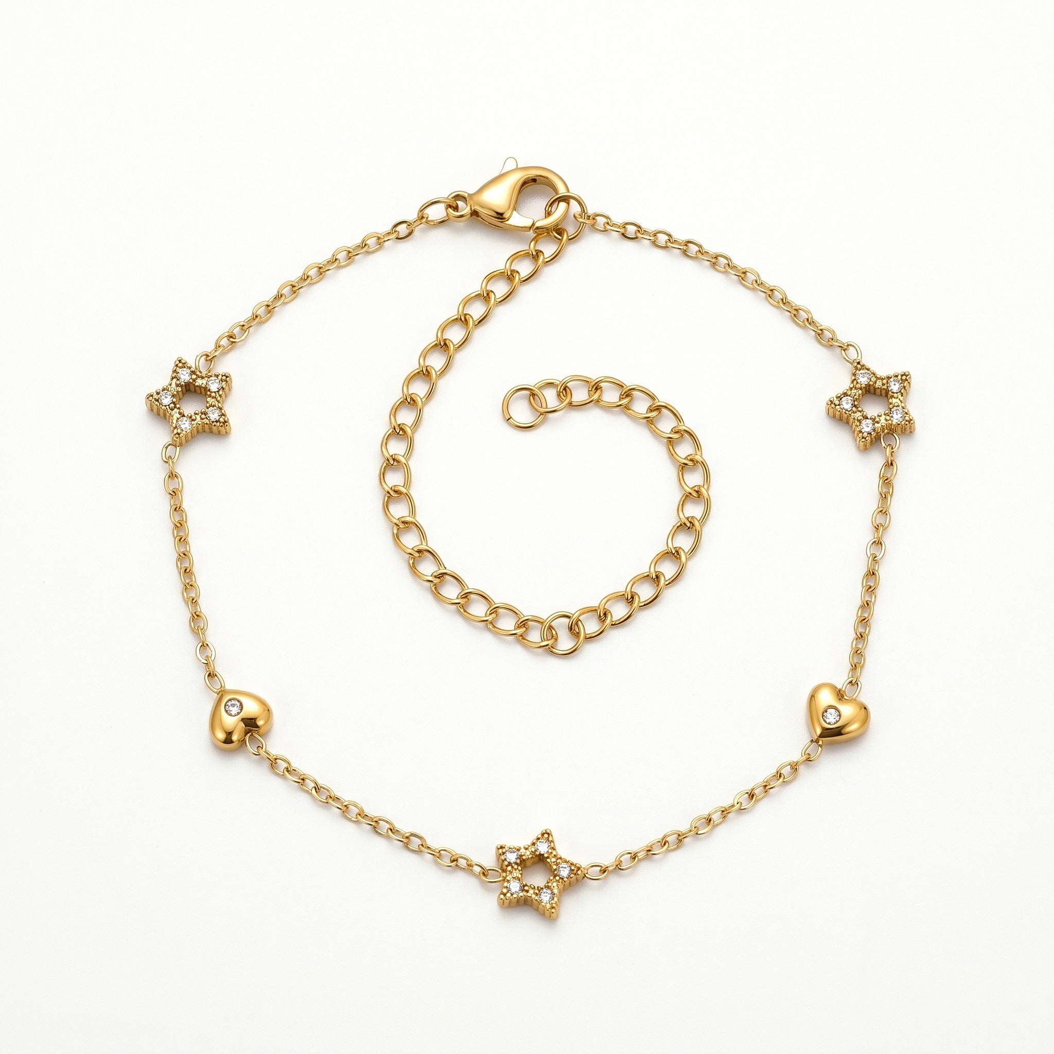 Gold-tone star and heart charm bracelet, laid out flat