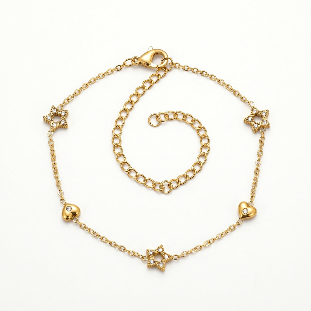 Gold-tone star and heart charm bracelet, laid out flat