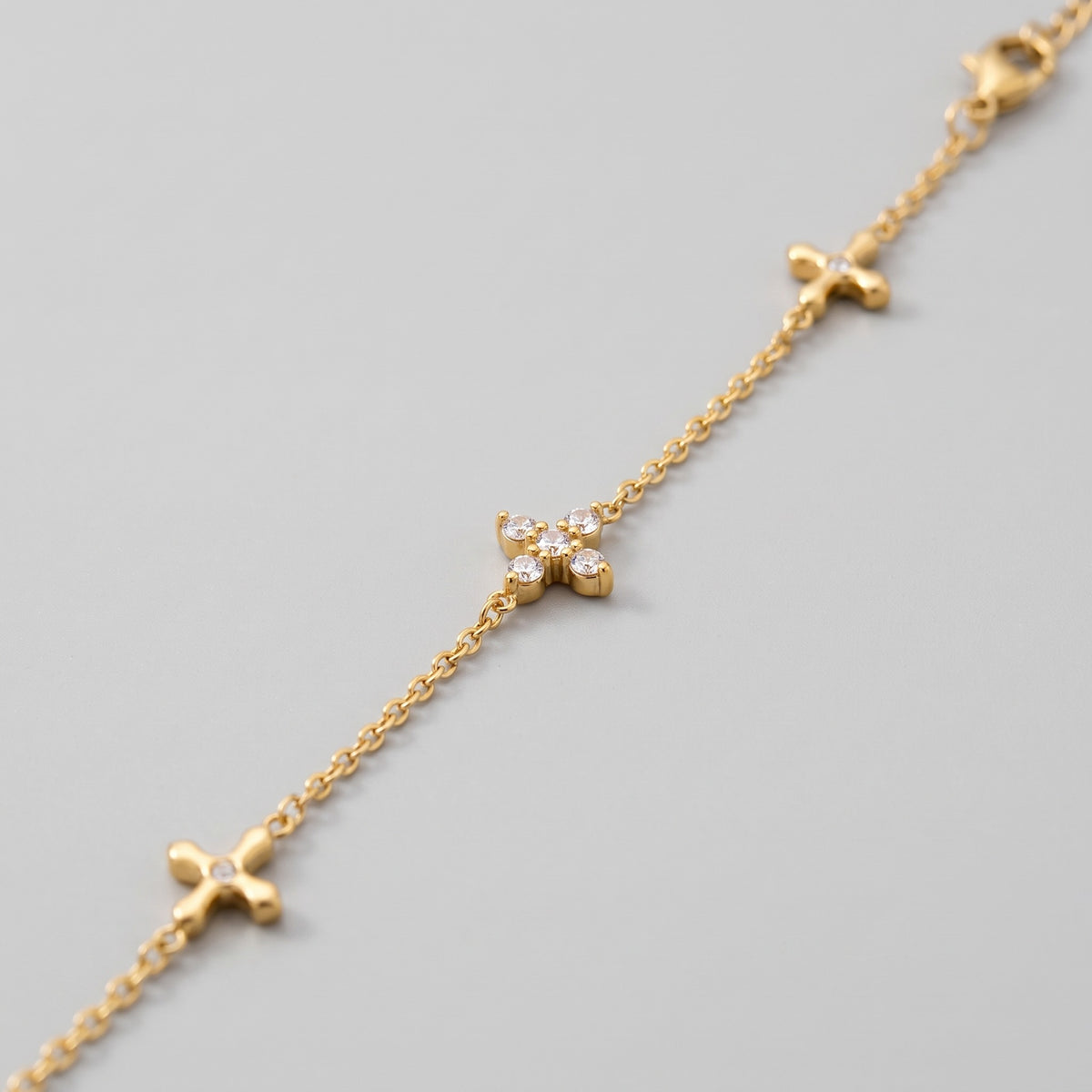 Close-up of the crystal crosses on the gold-tone chain